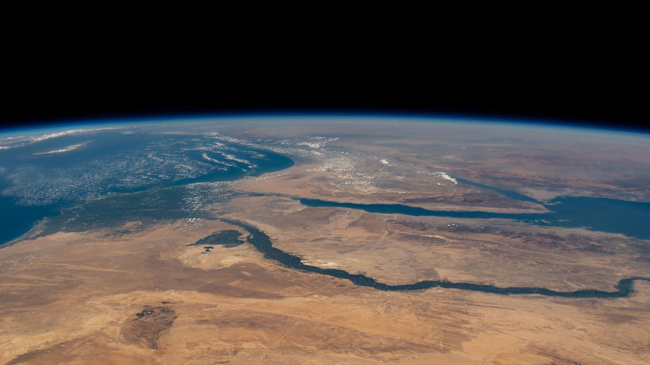 iss071e405499 (July 26, 2024) -- Flowing into the Mediterranean Sea, the Nile River is pictured from the International Space Station as it orbited 257 miles above Egypt. The Gulfs of Suez and Aqaba, feeding into the Red Sea, can also be seen in this photo, contrasting against the surrounding tan and orange terrain.