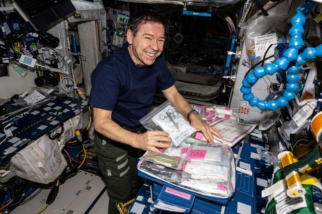 NASA astronaut Mike Barratt collects and organizes medical supplies