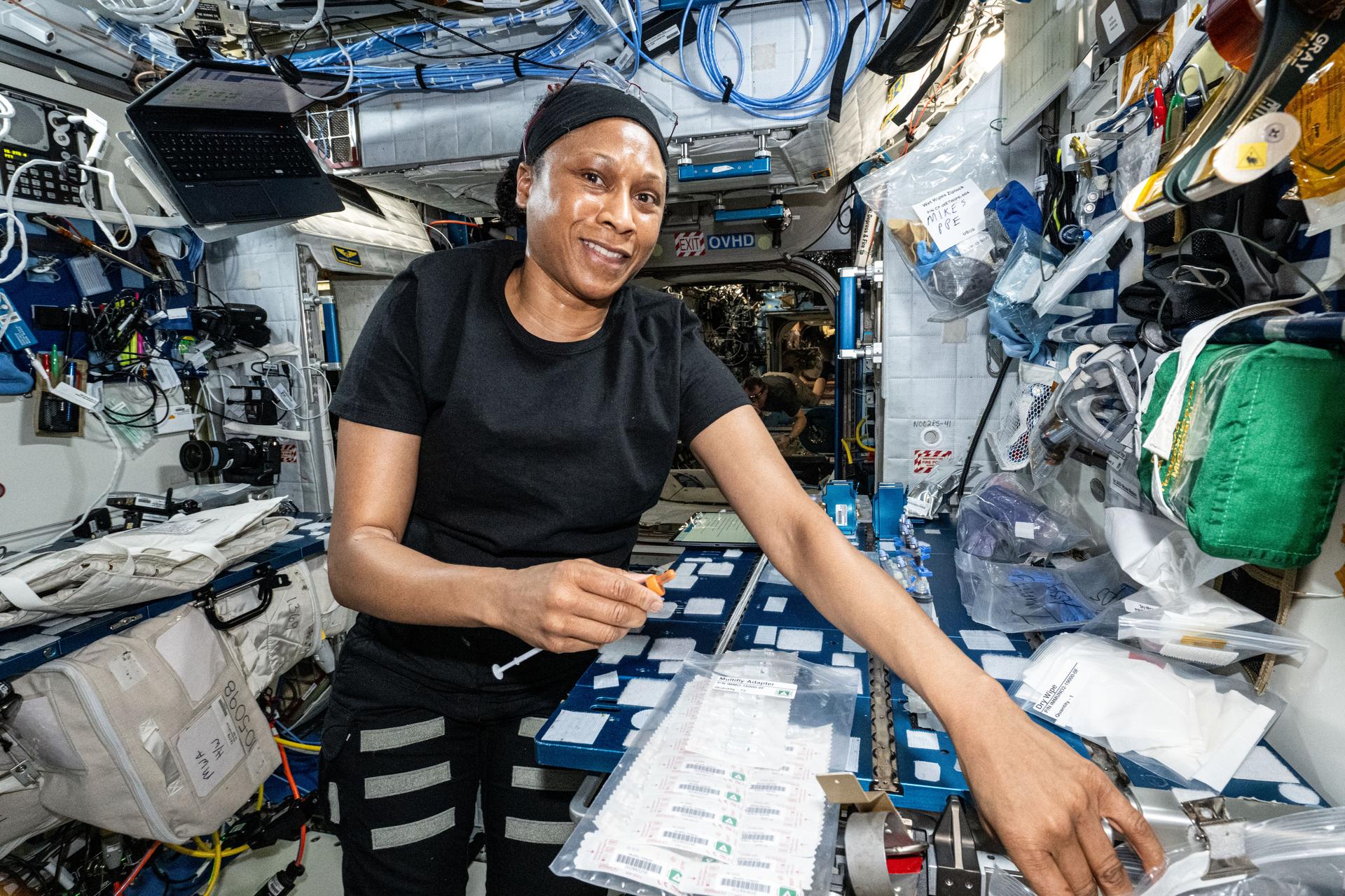 NASA female astronaut works with blood and saliva samples in lab aboard International Space Station.