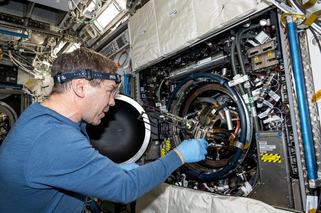 NASA image: Astronaut Mike Barratt replaces fuel bottles inside the Combustion Integrated Rack