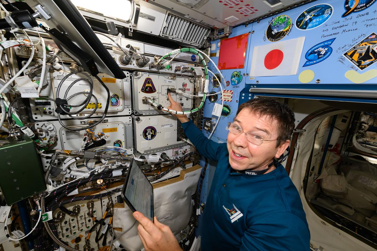 iss071e462410 (Aug. 9, 2024) --- NASA astronaut and Expedition 71 Flight Engineer Mike Barratt installs a new sample processor, also known as the Advanced Space Experiment Processor (ADSEP), inside the International Space Station's Kibo laboratory module. ADSEP can be packed with research samples and launched to space or returned to Earth aboard a Northrop Grumman Cygnus space freighter or a SpaceX Dragon cargo craft. ADSEP supports cell and tissue culturing, protein crystal growth, microorganism and bacteria studies, and materials science research.