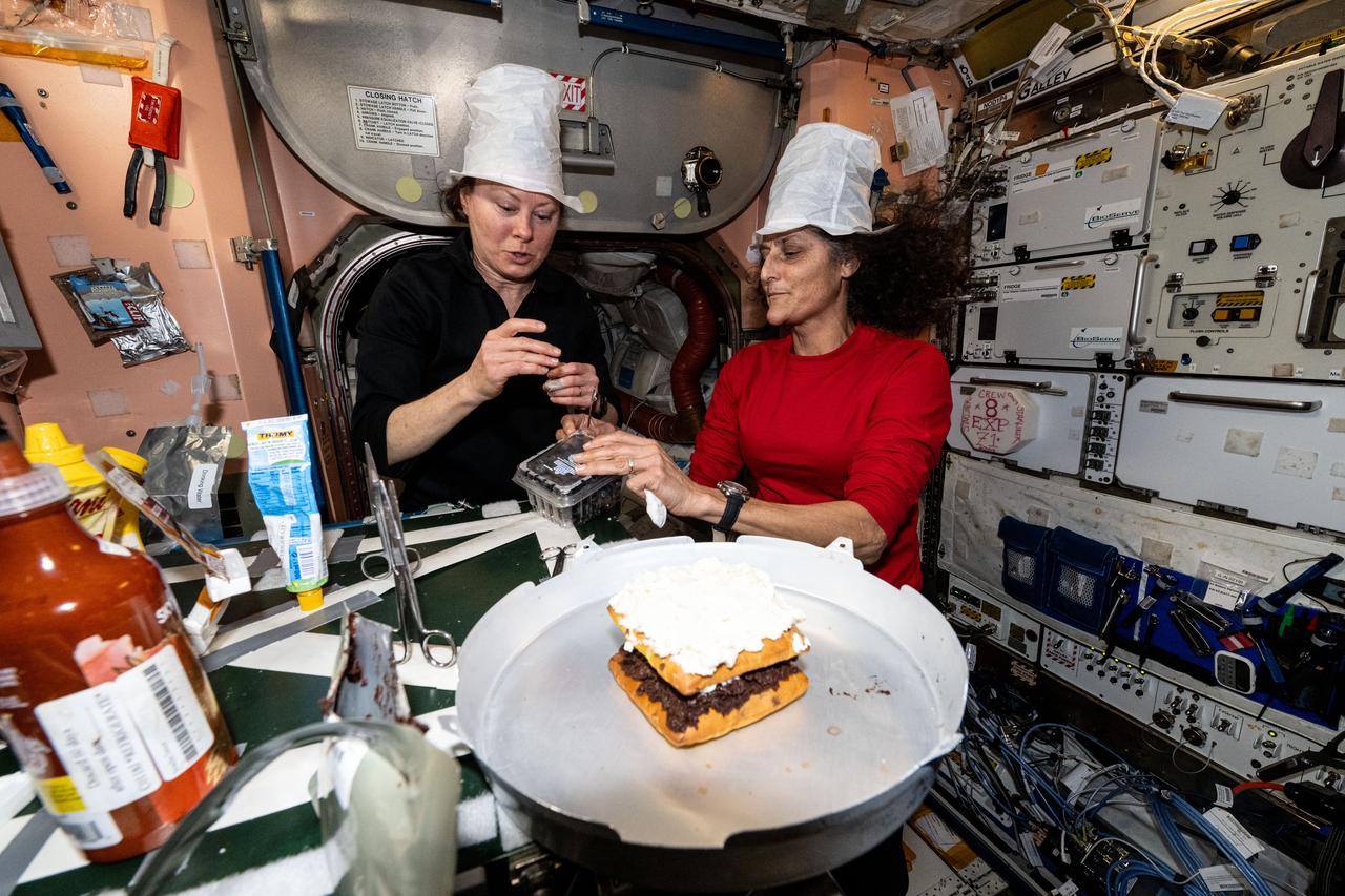 iss071e463611 (Aug. 11, 2024) --- NASA astronauts (from left) Tracy C. Dyson and Suni Williams enjoy an ice cream dessert with fresh ingredients delivered aboard the Northrop Grumman Cygnus space freighter. The duo was enjoying their delicious snack inside the International Space Station's Unity module where crews share meals in the galley.