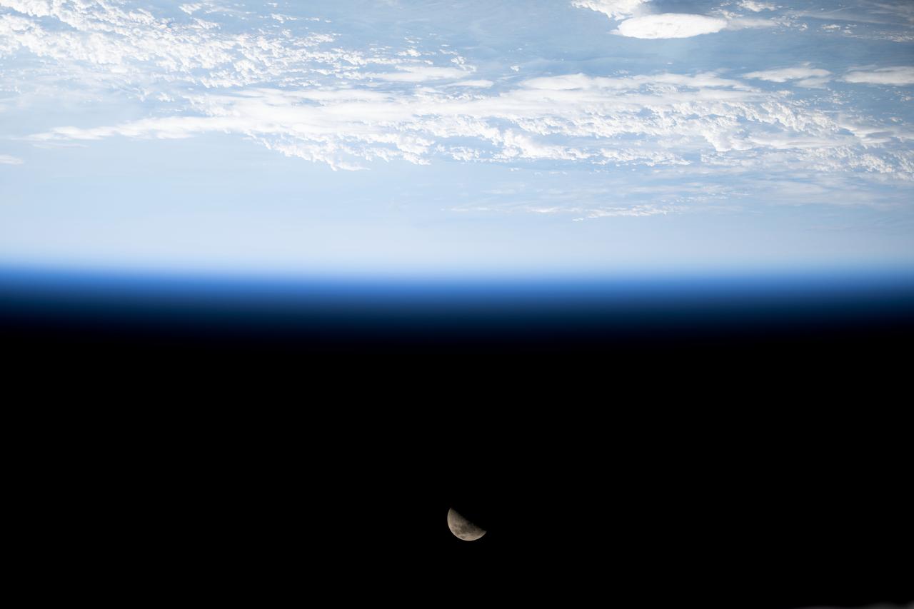 iss071e485735 (Aug. 12, 2024) --- The First Quarter Moon is pictured above Earth's horizon from the International Space Station as it orbited 263 miles above the English Channel in between France and England.