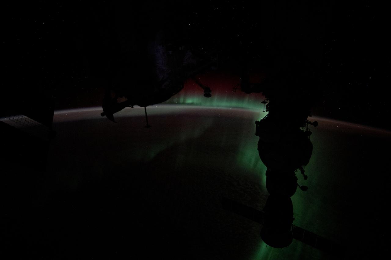 iss071e490546 (July 31, 2024) --- The Aurora Australis silhouettes the Soyuz MS-25 crew ship in this photograph from the International Space Station as it soared 272 miles above the Indian Ocean halfway between Australia and Antarctica.