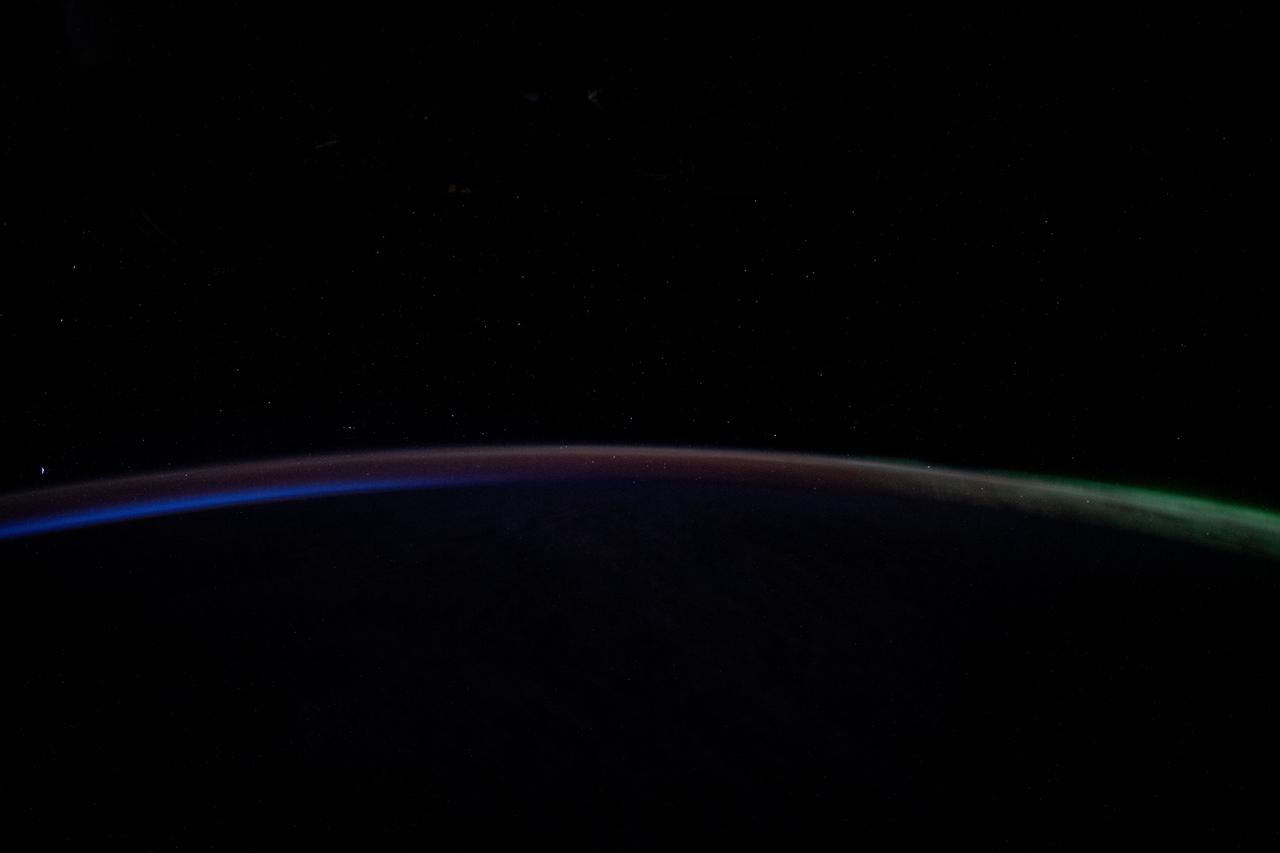 iss071e503153 (July 28, 2024) --- A dim Aurora Australis (at right) blankets the Earth's horizon and fades into a dawning orbital sunrise in this photograph from the International Space Station as it orbited 263 miles above the Pacific Ocean southeast of New Zealand.