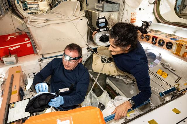 NASA image: Astronauts Butch Wilmore and Suni Williams inspect safety hardware