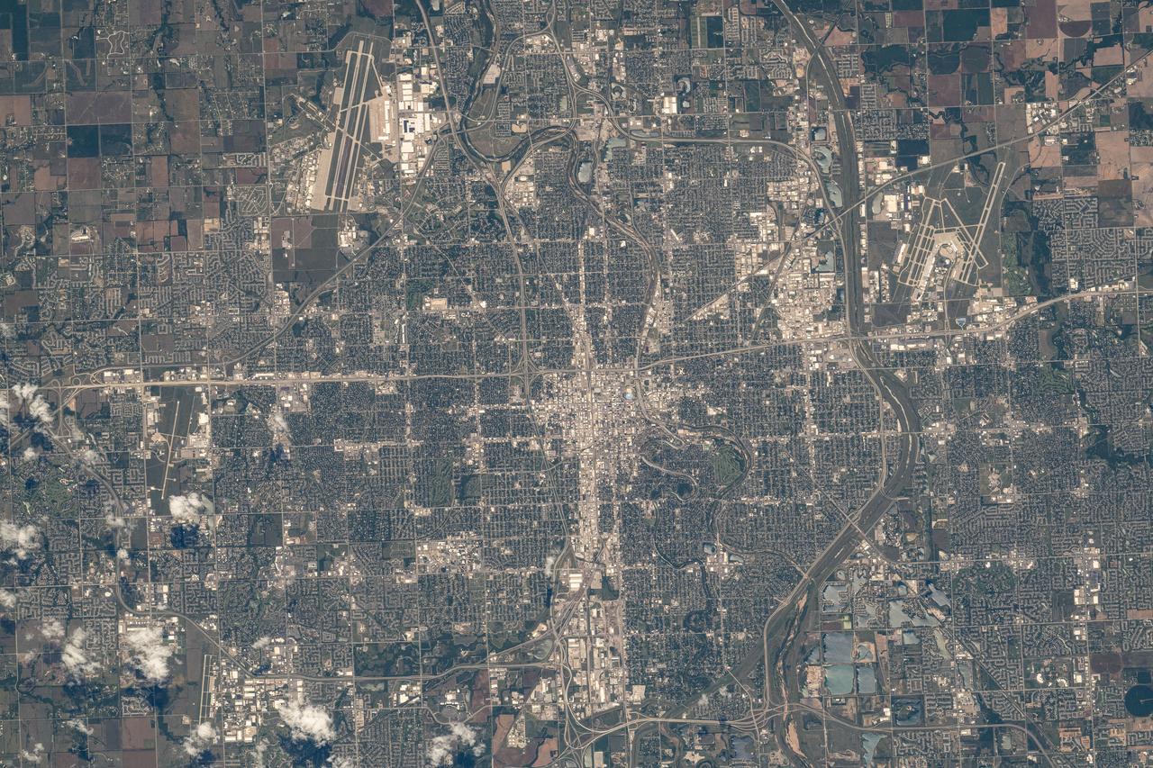 iss071e516926 (Aug. 18, 2024) --- Wichita, Kansas, a city with a population of nearly 400,000, with McConnell Air Force Base just outside the city limits (top left) and hosting the Dwight D. Eisenhower National Airport (upper right), is photographed from the International Space Station as it orbited 260 miles above.