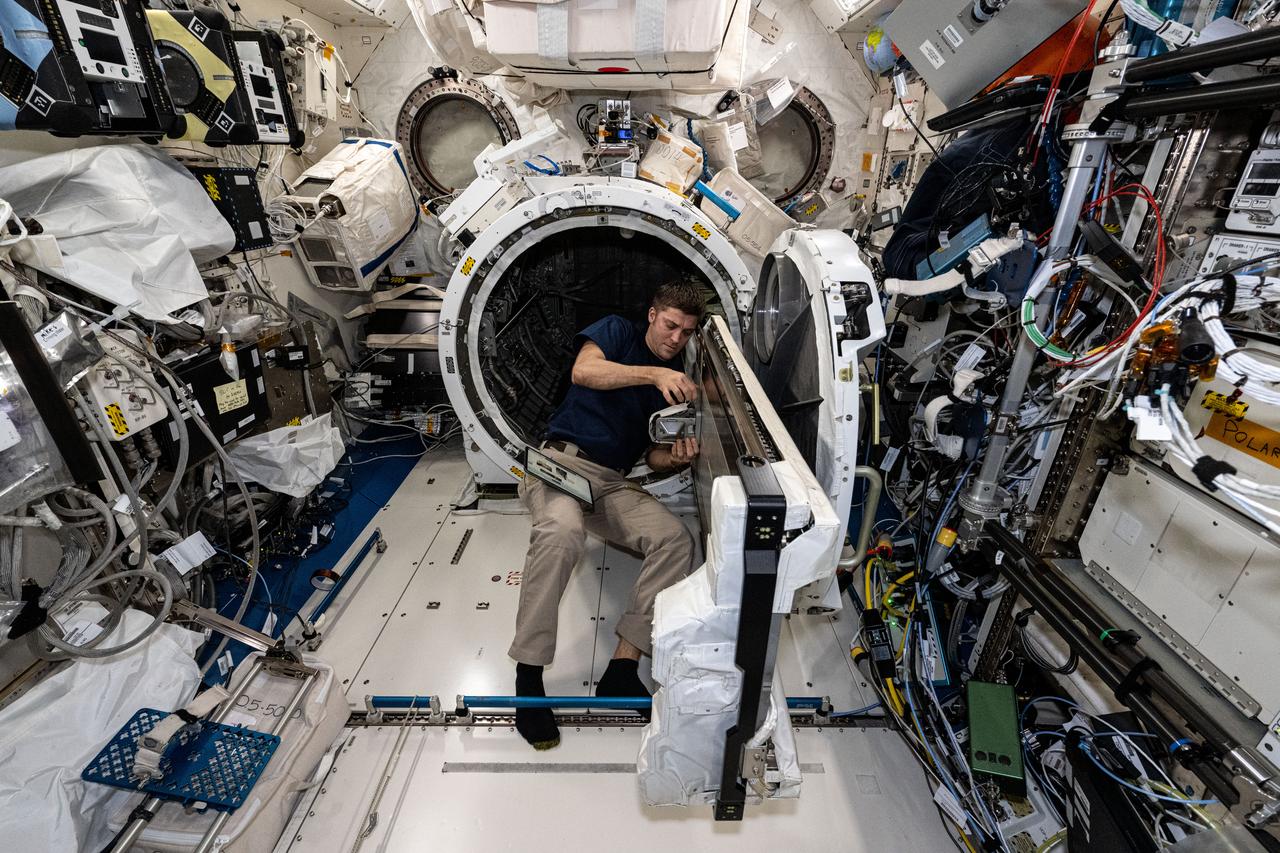 iss071e522256 (Aug. 21, 2024) --- NASA astronaut and Expedition 71 Flight Engineer Matthew Dominick checks CubeSat configurations packed inside launch cases installed in the Kibo laboratory module's Small Satellite Orbital Deployer.