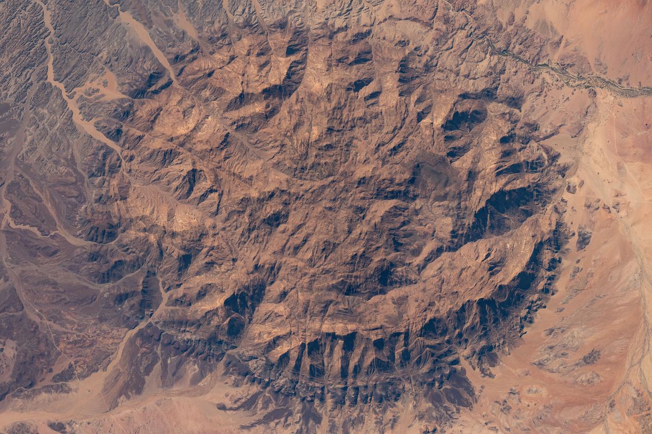 iss071e522460 (Aug. 20, 2024) --- The dome-shaped Brandburg Massif, near the Atlantic coast of central Namibia, containing Brandberg Mountain, the African nation's highest peak and ancient rock paintings going back at least 2,000 years, is pictured from the International Space Station as it orbited 261 miles above.