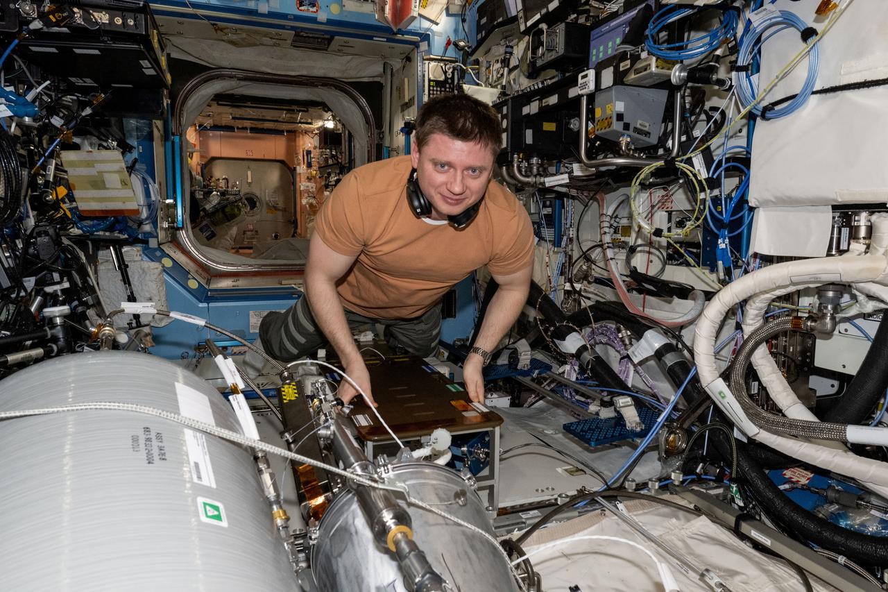 iss071e523250 (Aug. 21, 2024) --- Roscosmos cosmonaut and Expedition 71 Flight Engineer Alexander Grebenkin works on transferring water from resupply tanks to life support systems aboard the International Space Station's Destiny laboratory module
