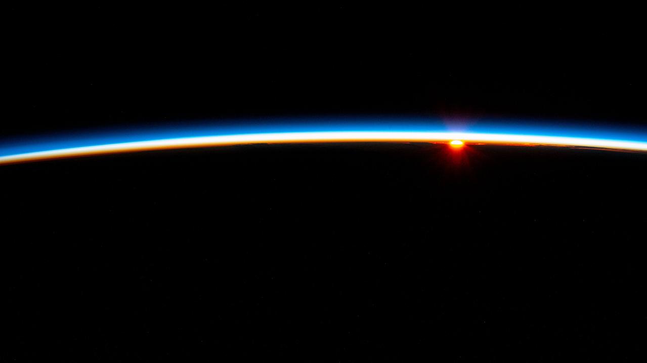 iss071e547275 (Aug. 22, 2024) --- The last rays of an orbital sunset fade below Earth's horizon illuminating the atmosphere in this photograph from the International Space Station as it soared 267 miles above the South Atlantic Ocean in between the tips of South America and South Africa.