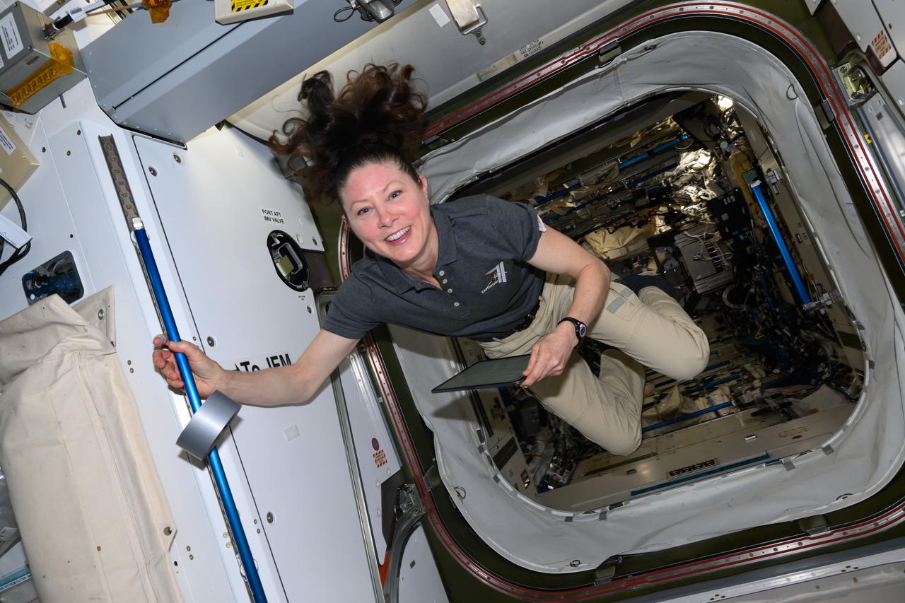 iss071e547724 (Aug. 14, 2024) --- NASA astronaut and Expedition 71 Flight Engineer Tracy C. Dyson smiles for a portrait in the vestibule between the Kibo laboratory module and the Harmony module aboard the International Space Station.