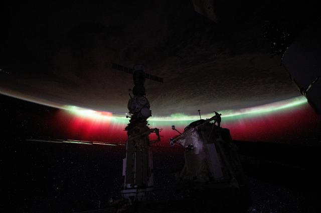 NASA image: A vibrant green and red aurora shimmers above New Zealand