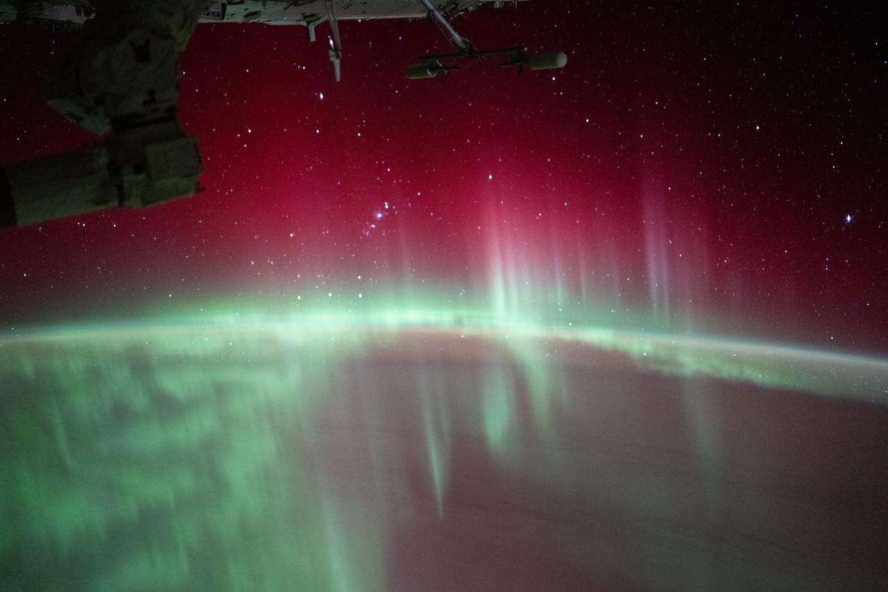 iss071e564695 (Aug. 11, 2024) -- In this long-exposure shot taken from the International Space Station as it orbited 268 miles above the Indian Ocean, stars glitter above green and red auroras swirling through Earth's atmosphere.