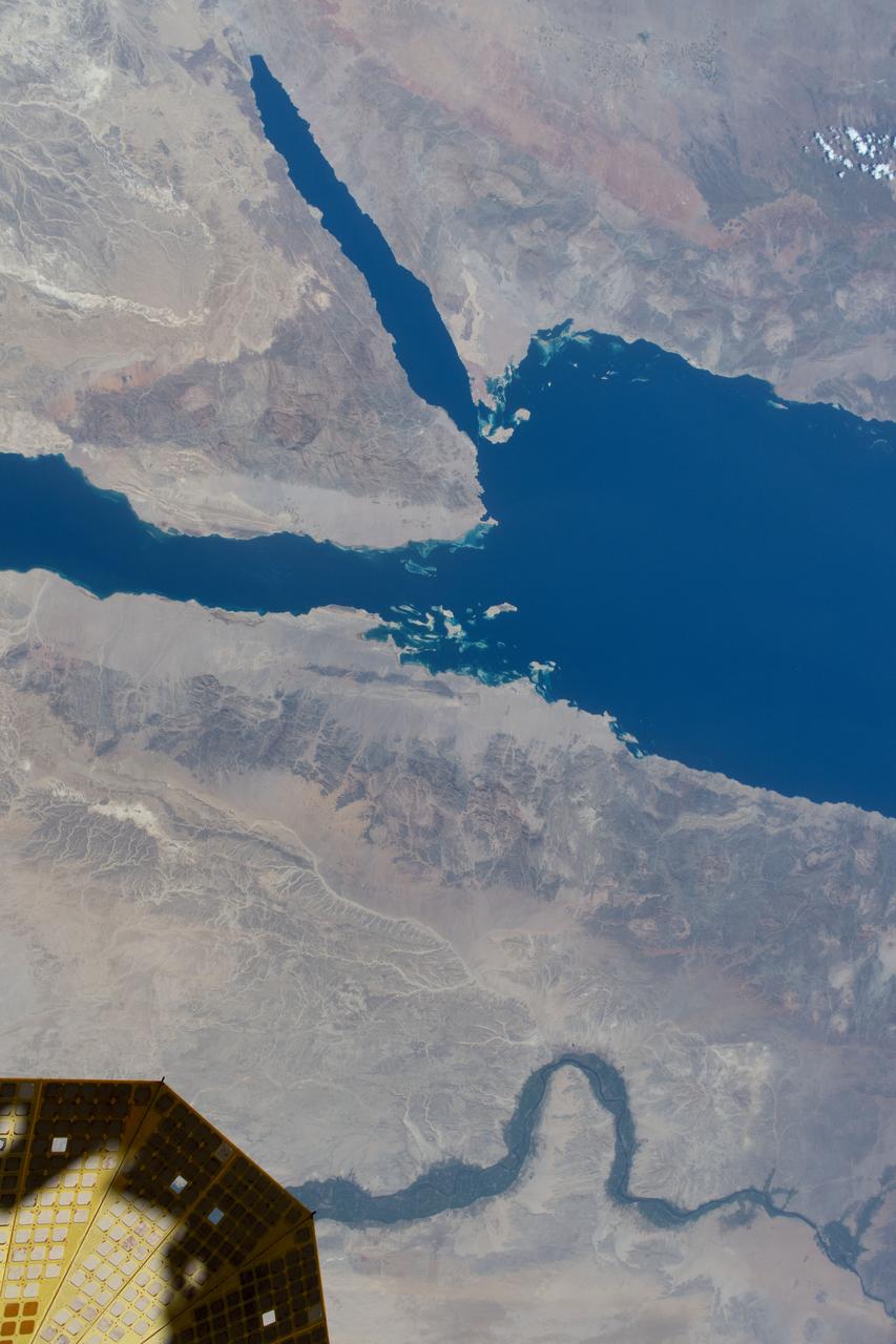 iss071e578476 (Aug. 14, 2024) --- The Nile River runs alongside the Red Sea in this photograph from the International Space Station as it orbited 258 miles above the Middle East. At lower left, is one of the two cymbal-shaped UltraFlex solar arrays that power the Northrop Grumman space freighter.