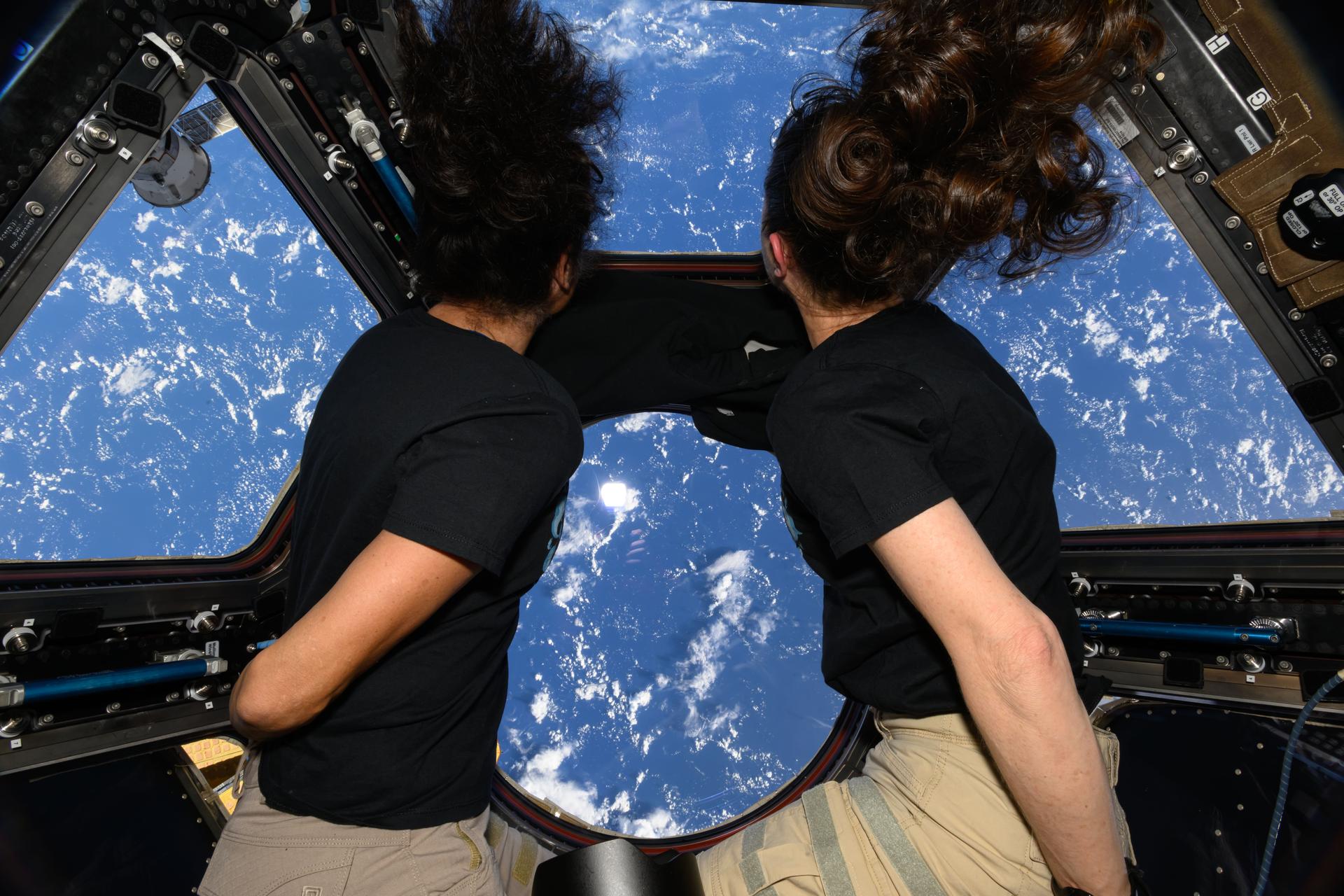 Expedition 71 Flight Engineers (from left) Suni Williams and Tracy C. Dyson look out the cupola, the International Space Station's "window to the wor…