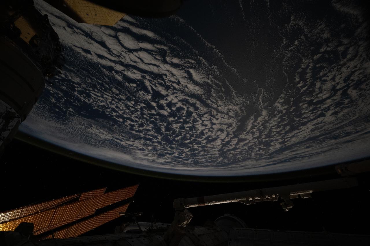 iss071e619284 (Aug. 20, 2024) --- Clouds stream above the southern Indian Ocean in between Madagascar and the French and Southern Antarctic Lands in this nighttime photograph from the International Space Station as it orbited 265 miles above.