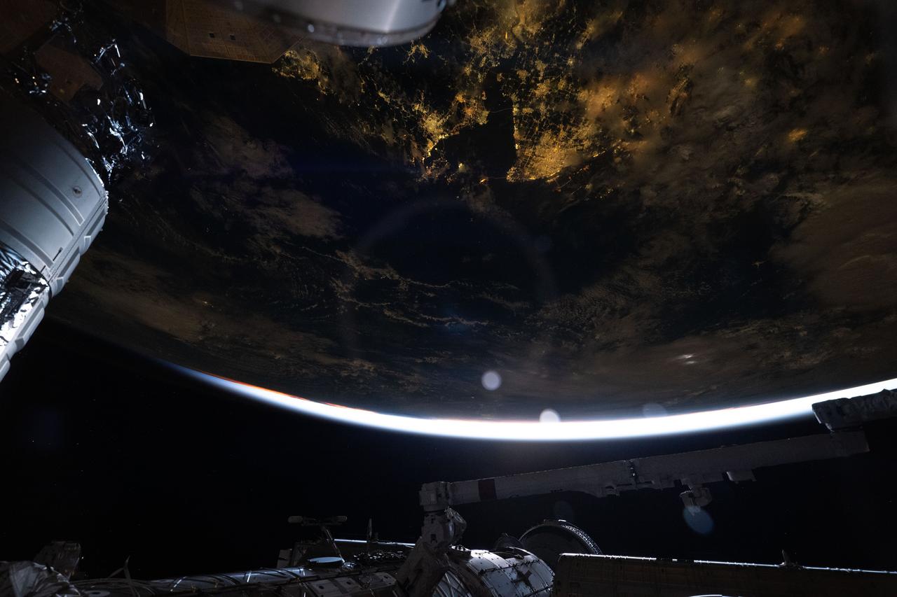iss071e621477 (Aug. 20, 2024) --- The city lights of Shanghai, China, on the coast of the East China Sea, are pictured from the International Space Station as it soared 262 miles above into an orbital sunrise.