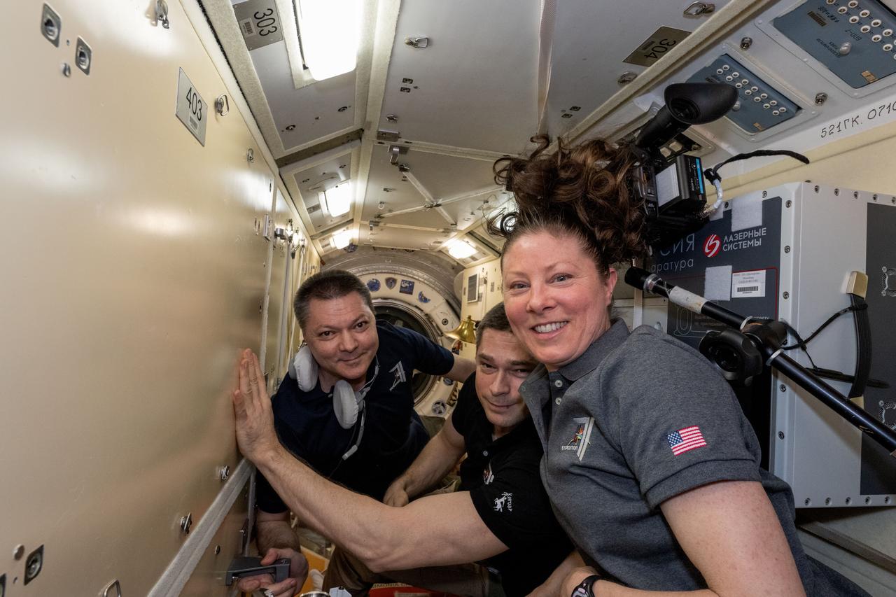 iss071e629763 (Sept. 11, 2024) --- Expedition 71 crew members (from left) Oleg Kononenko and Nikolai Chub, both Roscosmos cosmonauts, and NASA astronaut Tracy C. Dyson pose for a portrait inside the International Space Station's Rassvet module.