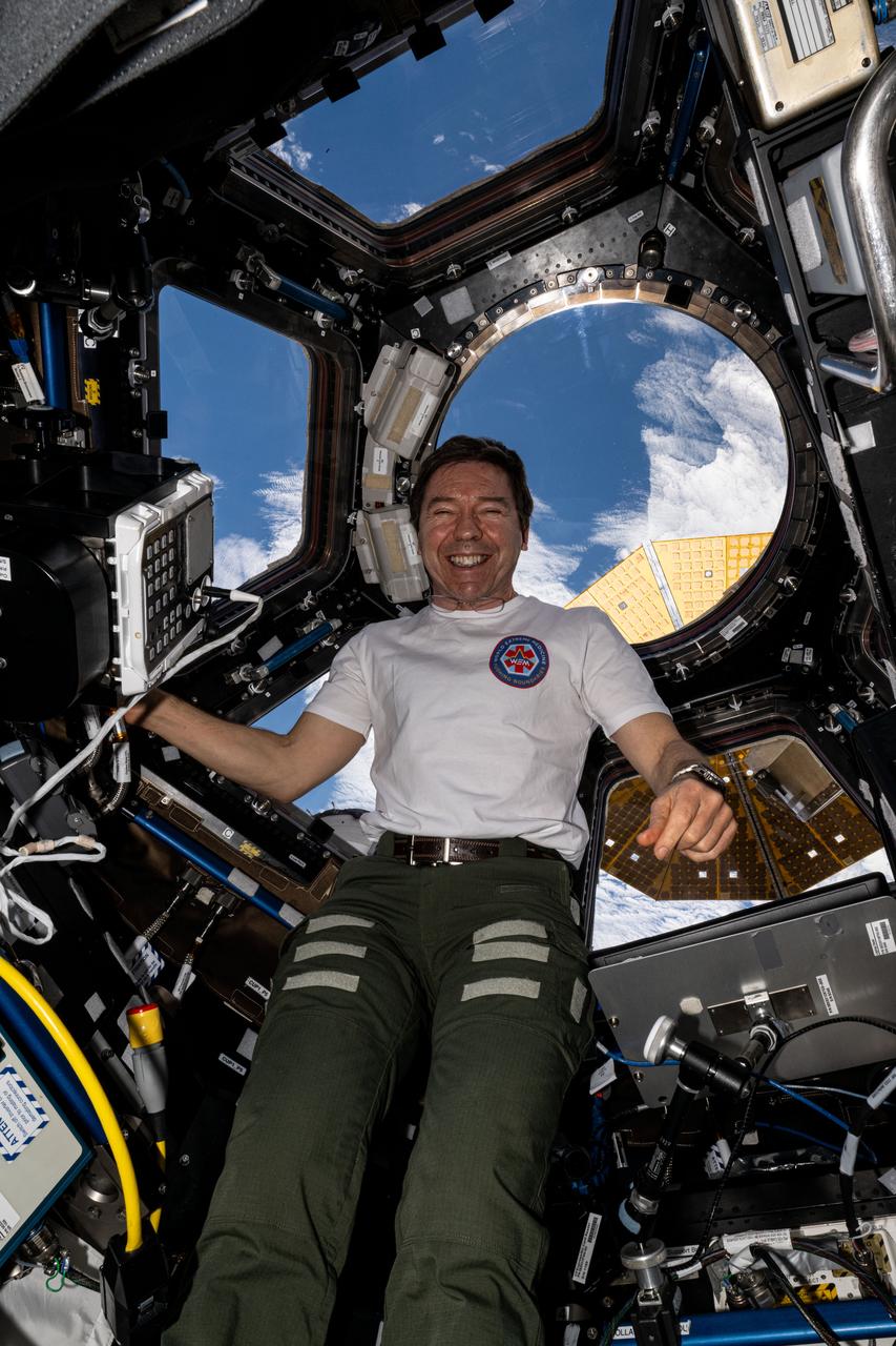 iss071e673561 (Sept. 17, 2024) -- NASA astronaut Mike Barratt smiles for a photo while inside the International Space Station's cupola as the orbiting lab soared 269 miles above the South Atlantic Ocean.