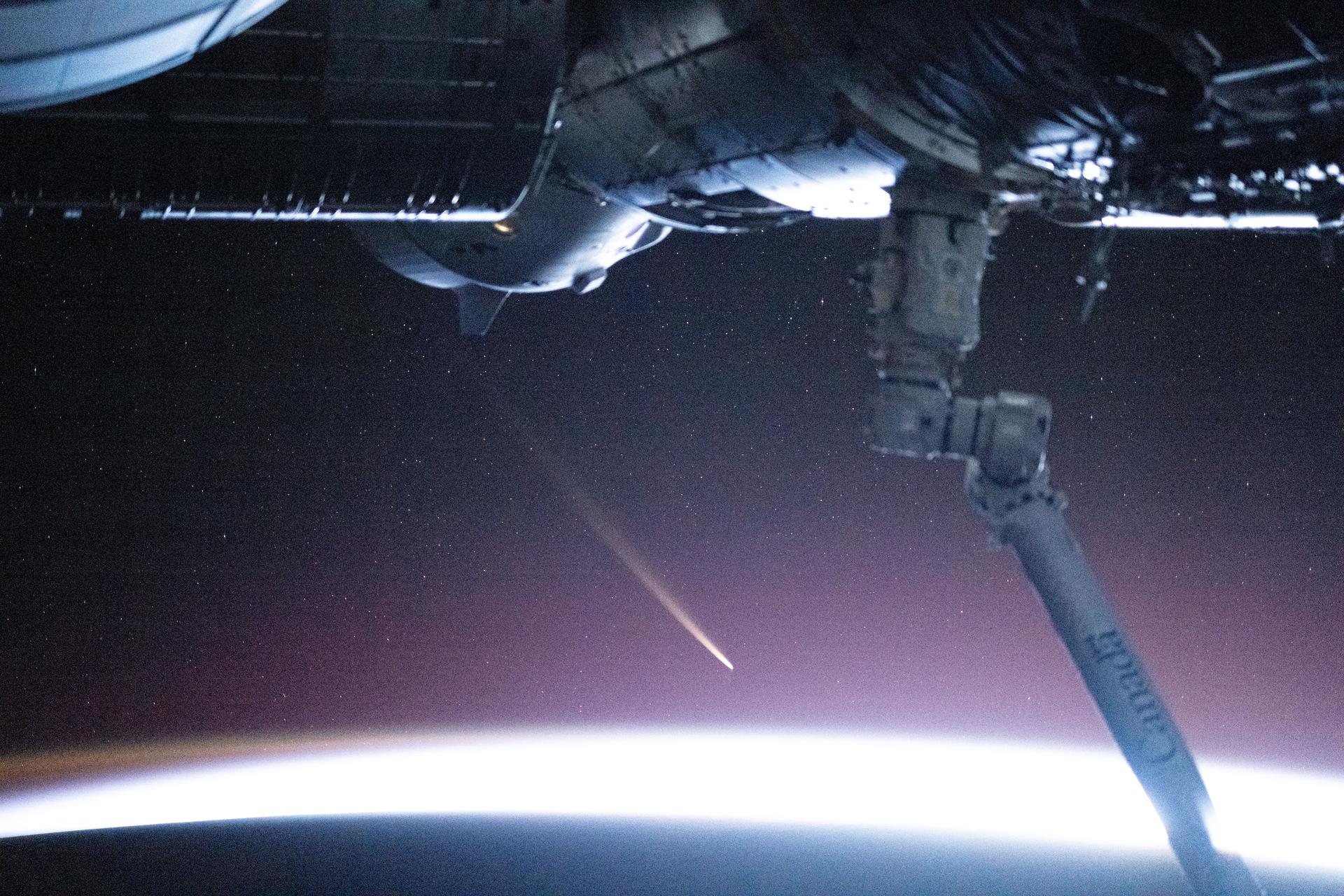 The non-periodic Comet C/2024 G3 (ATLAS) is pictured seemingly above Earth's atmosphere though it was actually about 235 million miles away and heading for a trip around the Sun. The International Space Station was orbiting 272 miles above the southern Atlantic Ocean in between the Falkland Islands (Islas Malvinas) and South Georgia and the South Sandwich Islands at the time of this photograph. Credit: NASA/Don Pettit