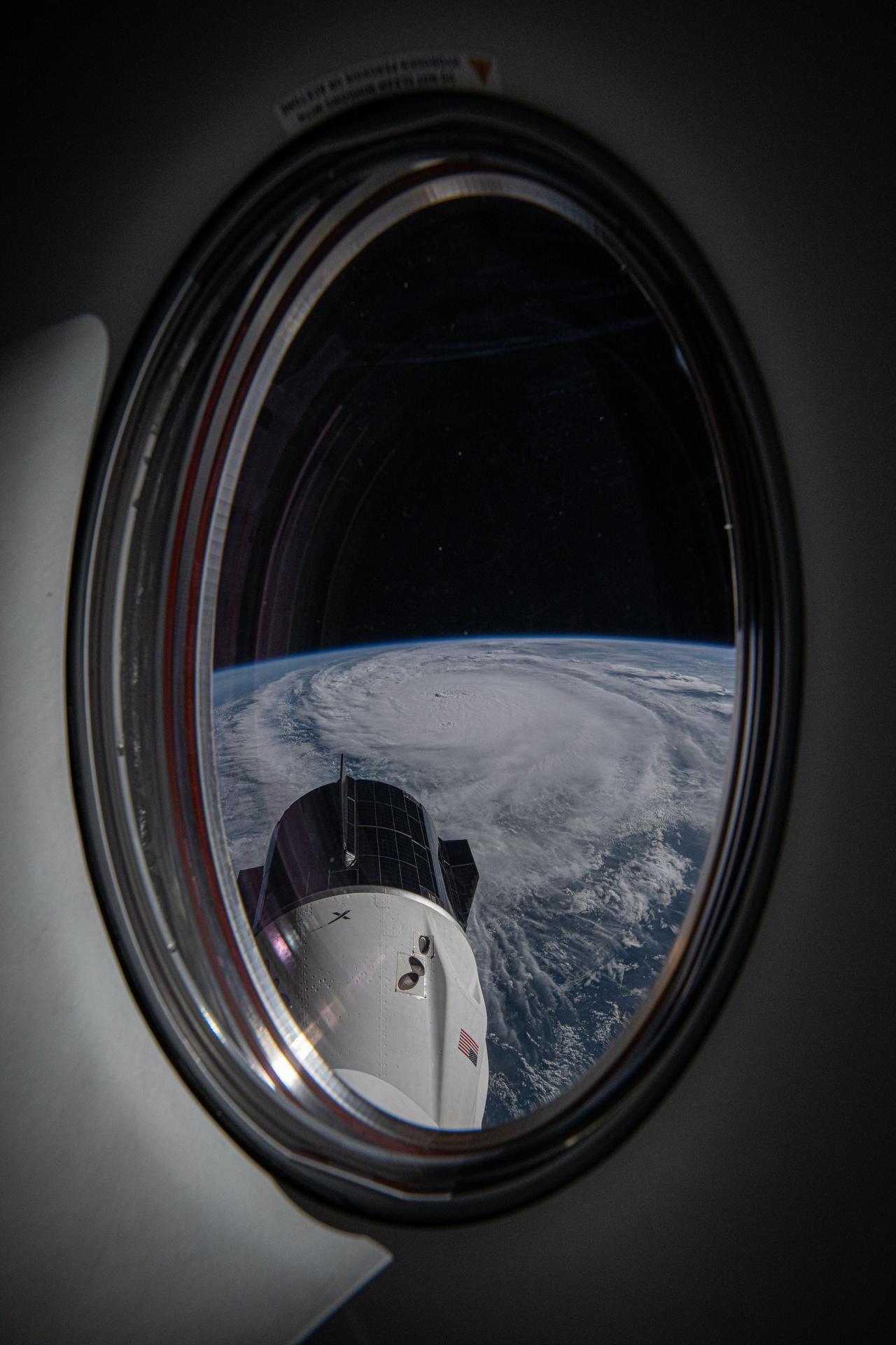 Hurricane Milton is pictured as a category 4 storm in the Gulf of Mexico nearing the coast of Florida in this photograph from the International Space Station as it orbited 257 miles above. The SpaceX Dragon Freedom spacecraft is also pictured from a window on the Dragon Endeavour spacecraft.