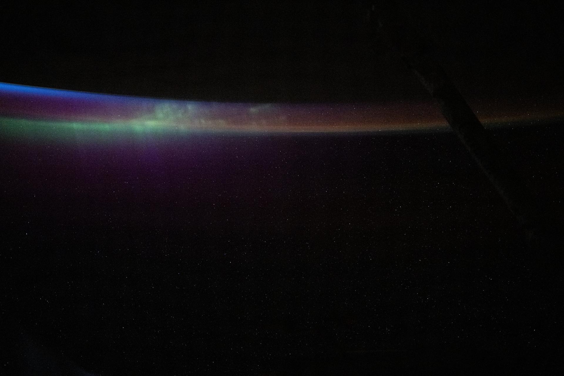 The aurora australis blends into Earth's atmospheric glow in this photograph from the International Space Station as it soared into an orbital sunset 274 miles above the South Pacific Ocean.