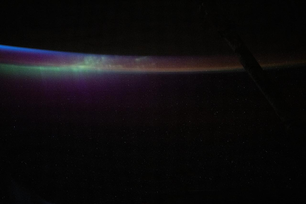 iss072e030161 (Oct. 10, 2024) --- The aurora australis blends into Earth's atmospheric glow in this photograph from the International Space Station as it soared into an orbital sunset 274 miles above the South Pacific Ocean.