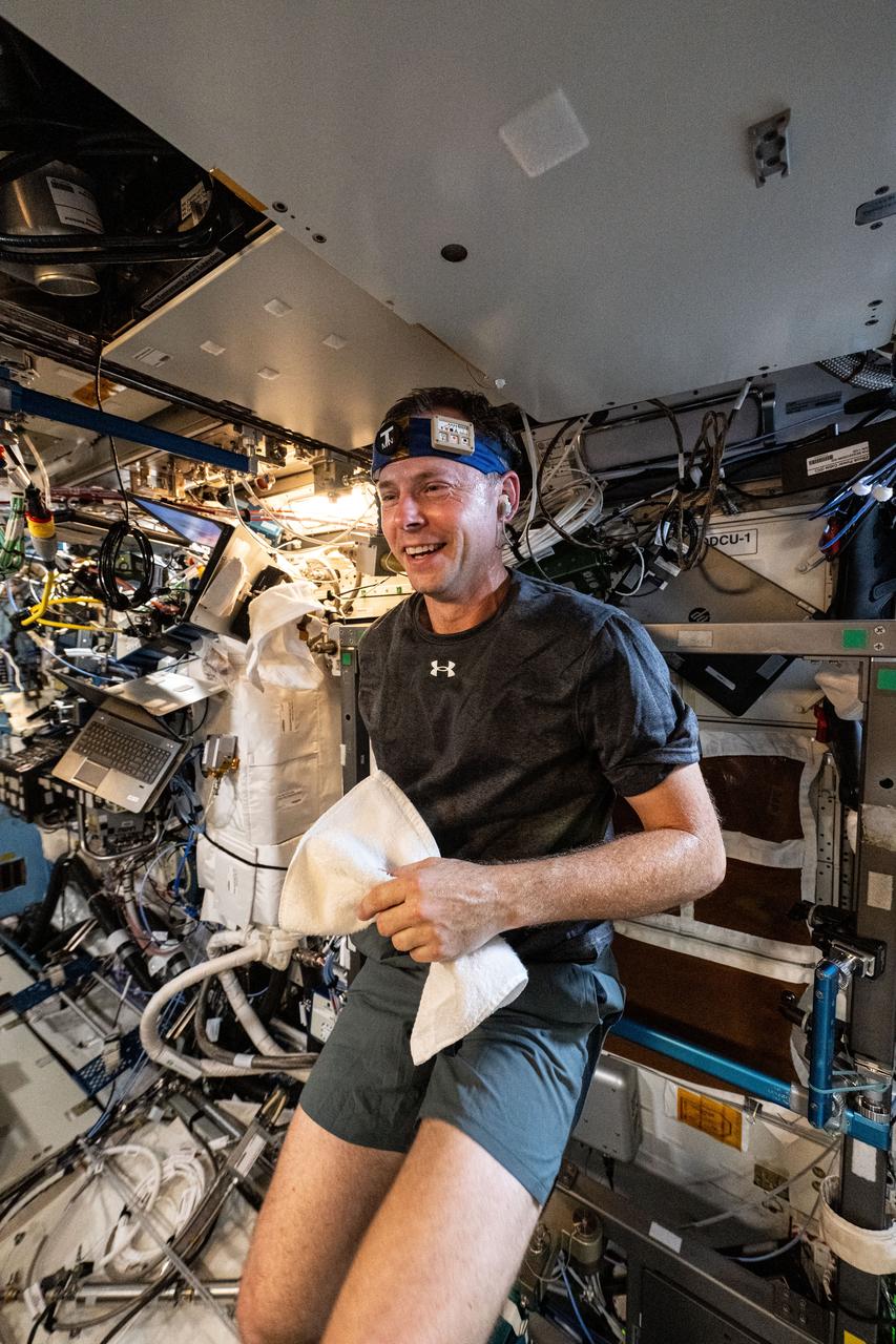 iss072e031342 (10/9/2024) --- NASA astronaut Nick Hague works out wearing T-mini, a headband with a thermosensor that tracks core body temperature. Scientists can use body and environment metrics to study the body’s adaptions to and function in microgravity.