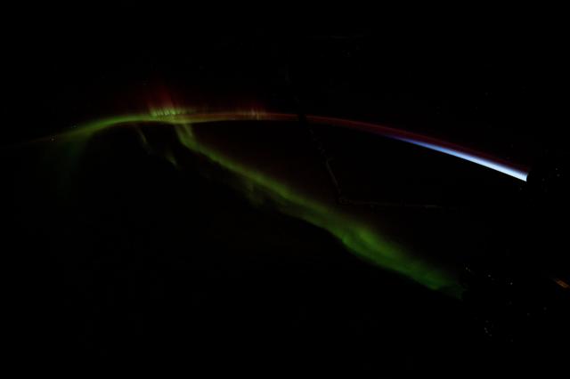 NASA image: A wispy aurora australis streams over the Earth