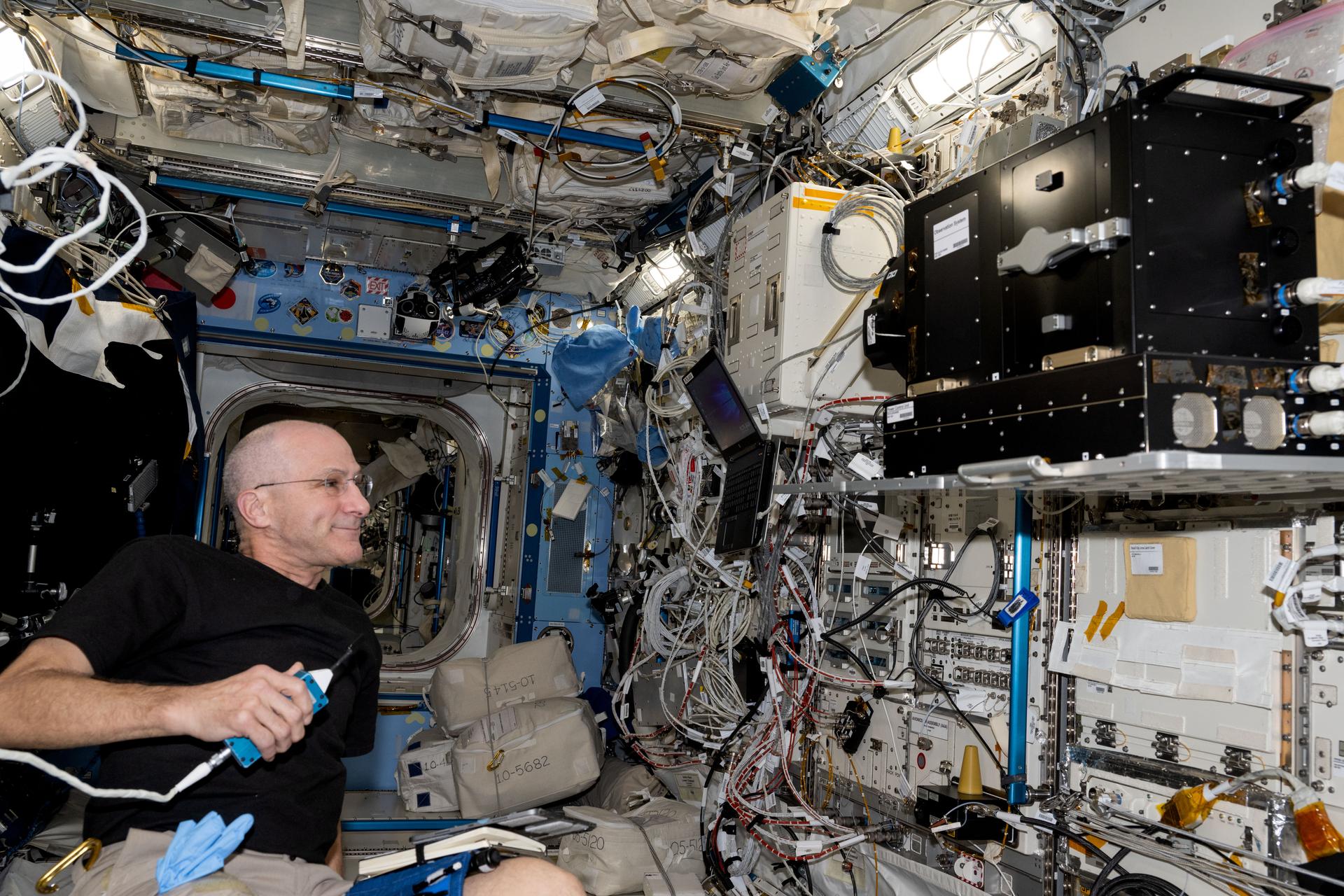 NASA astronaut and Expedition 72 Flight Engineer Don Pettit works inside the Kibo laboratory module checking out biology imaging hardware, the Tele-Luminescence Analysis System (TELLAS), that can detect space-caused inflammatory changes to tissues and genes in organisms.
