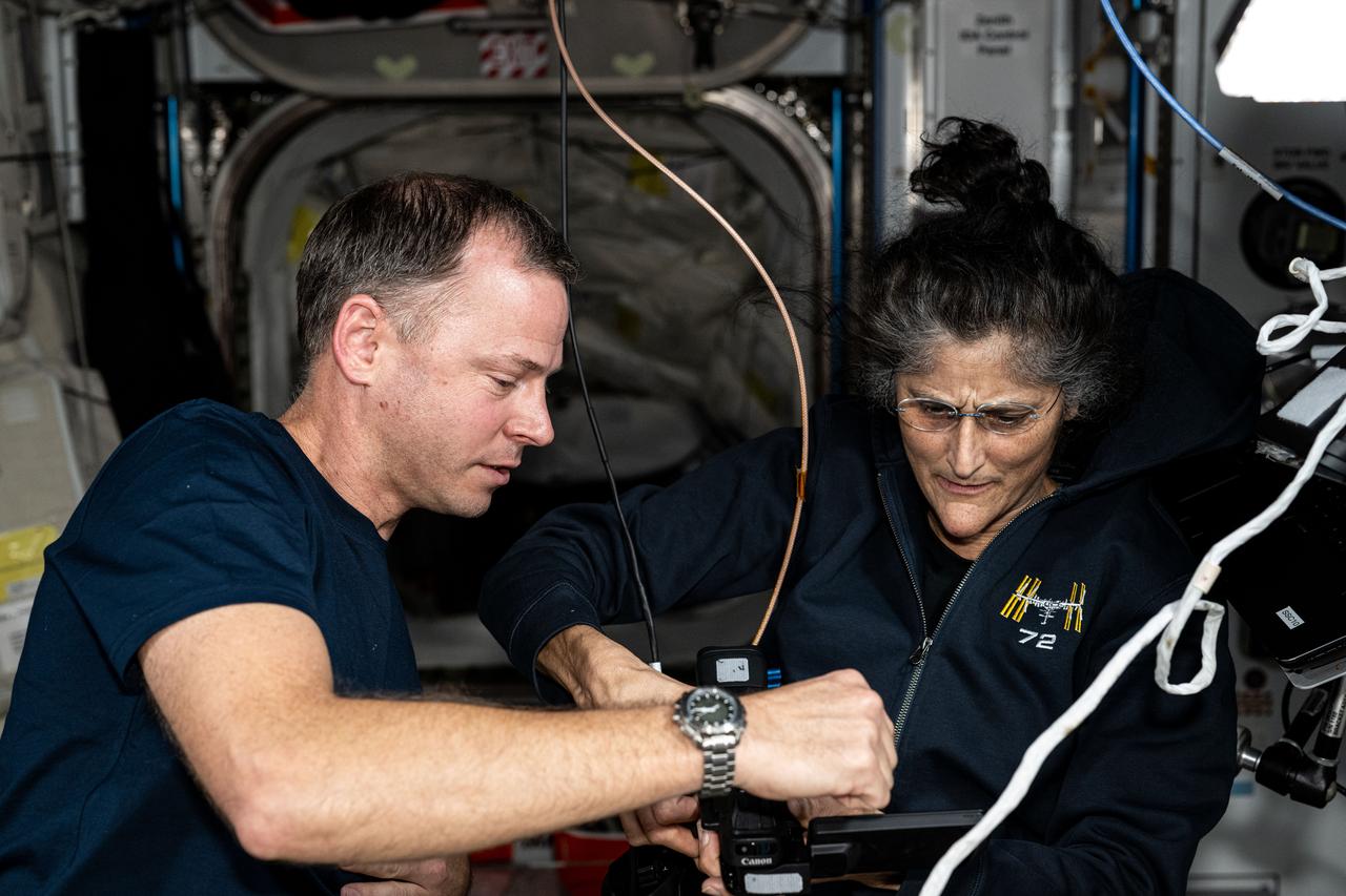 iss072e063703 (Oct. 15, 2024) --- NASA astronauts Nick Hague and Suni Williams, Expedition 72 Flight Engineer and Commander respectively, discuss orbital lab maintenance procedures aboard the International Space Station.