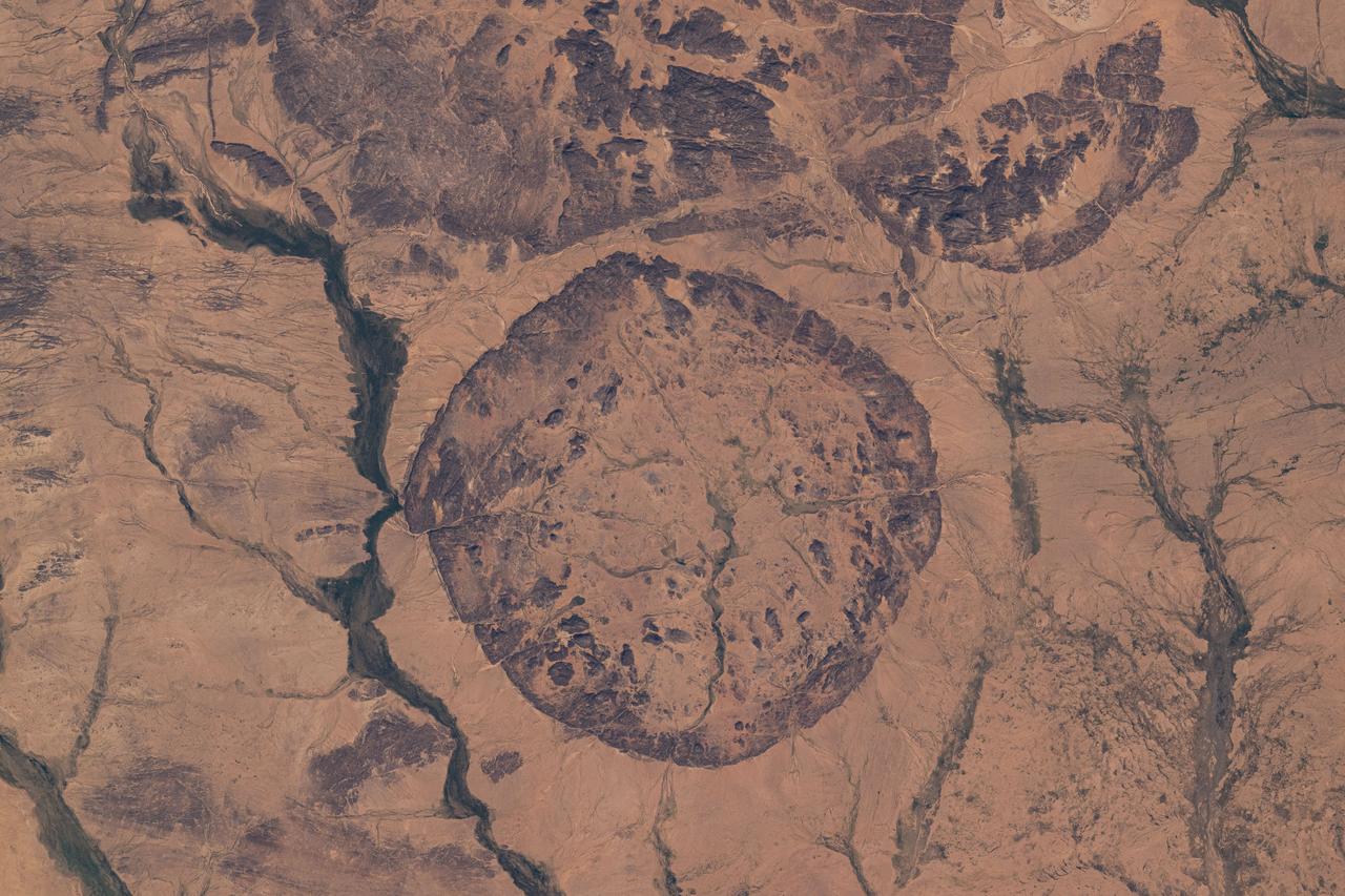 iss072e069133 (Oct. 16, 2024) --- Ancient settlements surround this circular, geological feature in the hot, desert climate of Mali pictured from the International Space Station as it orbited 258 miles above the African nation.
