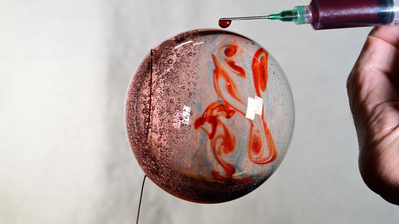 iss072e069543 (Oct. 19, 2024) --- Space science is fun! NASA astronaut and Expedition 72 Flight Engineer Don Pettit fills this sphere of water with food coloring creating a Jupiter-like effect in the microgravity environment of the International Space Station.