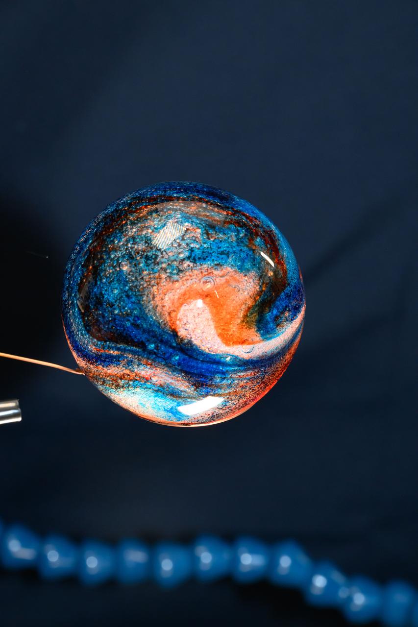 iss072e069592 (Oct. 19, 2024) --- Space science is fun! NASA astronaut and Expedition 72 Flight Engineer Don Pettit filled this sphere of water with food coloring creating a Jupiter-like effect in the microgravity environment of the International Space Station.