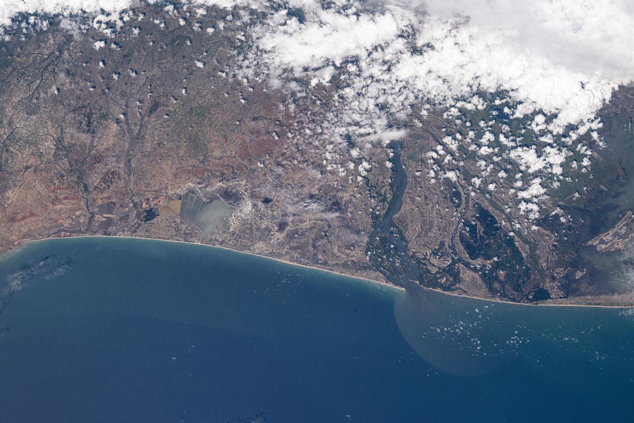 iss072e097260 (Oct. 22, 2024) --- Volta River in the African nation of Ghana, east of the Songoor Lagoon Protected Area (left), leads into the Gulf of Guinea in this photograph from the International Space Station as it orbited 258 miles above.