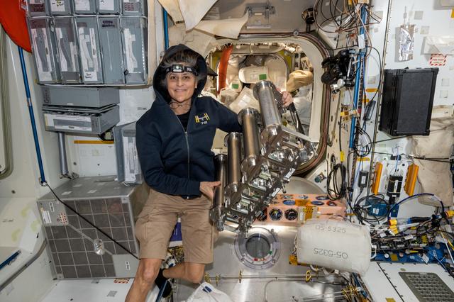 NASA image: Astronaut Suni Williams replaces particulate filters on the water recovery system