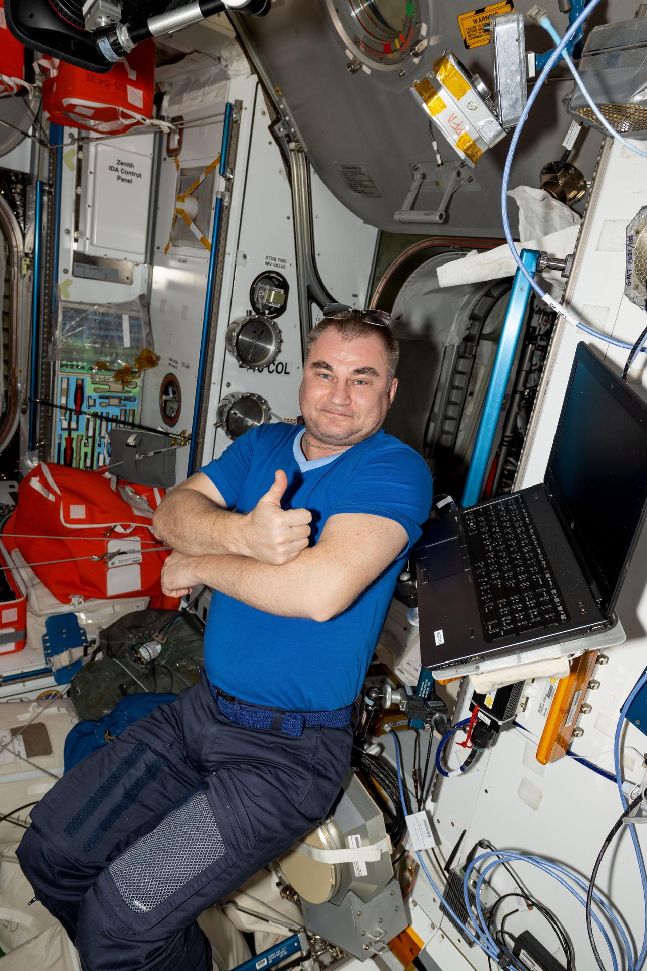 Roscosmos cosmonaut and Expedition 72 Flight Engineer Alexey Ovchinin gives a thumbs up inside the Internationla Space Station's Harmony module.
