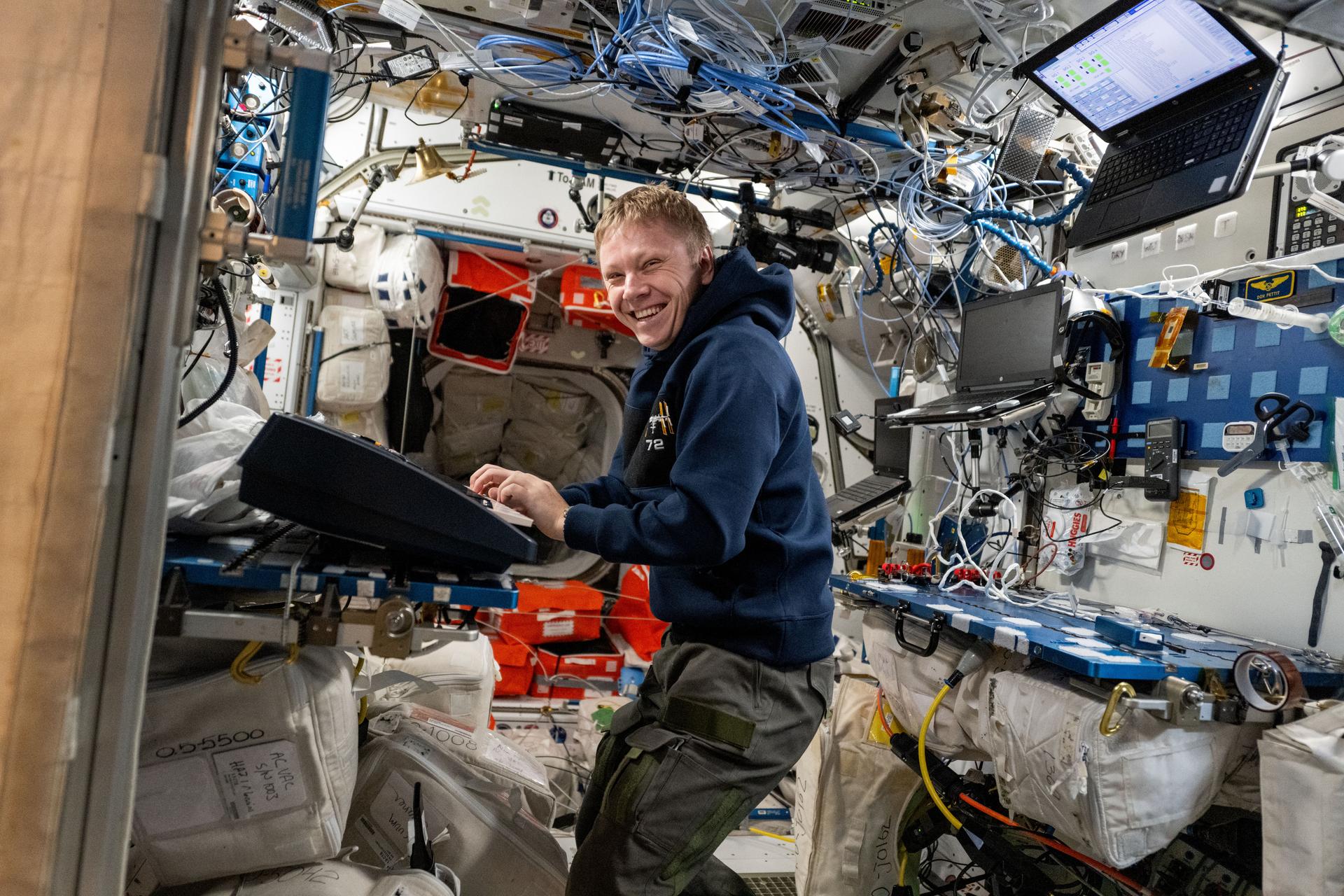 Roscosmos cosmonaut and Expedition 72 Flight Engineer Alexey Ovchinin gives a thumbs up inside the Internationla Space Station's Harmony module.