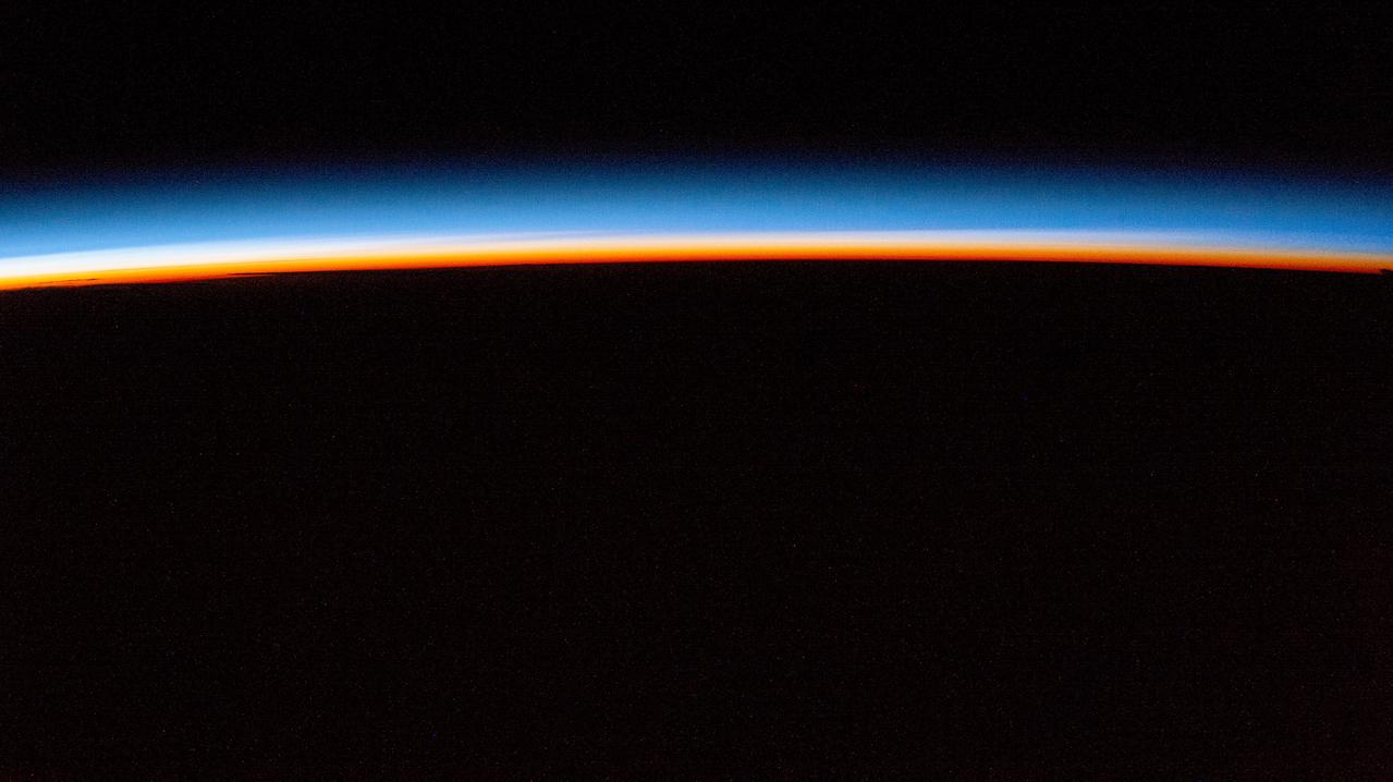 iss072e143829 (Nov. 2, 2024) -- The first rays of an orbital sunrise display pink and blue hues in Earth's atmosphere as the International Space Station orbited 257 miles above Austria.