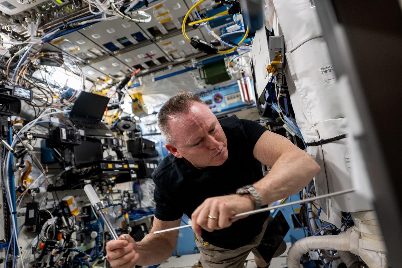 iss072e145964 (Nov. 6, 2024) --- NASA astronaut and Expedition 72 Flight Engineer Butch Wilmore installs the Powered Ascent Utility Locker-2 (PAUL-2) in an EXPRESS rack aboard the International Space Station's Destiny laboratory module. PAUL-2 was launched aboard the SpaceX Dragon cargo spacecraft and can provide power and temeperature control for experiments packed inside Dragon during its trip to the orbital outpost.