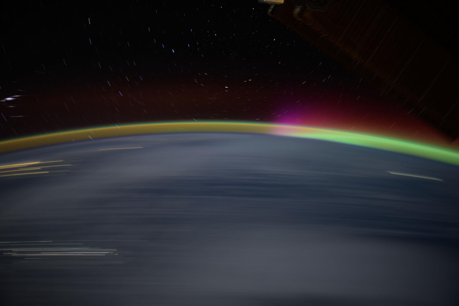 The streaks of city lights, star trails, an aurora, and Earth's atmospheric glow highlight this long-duration photograph taken from the International Space Station as it orbited 259 miles above the North Pacific Ocean off the coast of Japan.