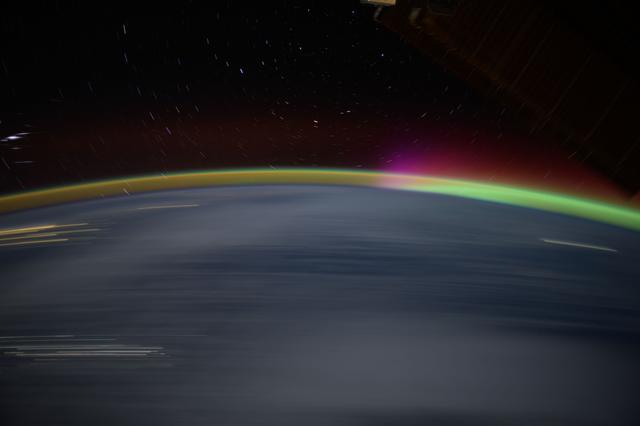 NASA image: Streaks of city lights, star trails, an aurora, and Earth's atmospheric glow