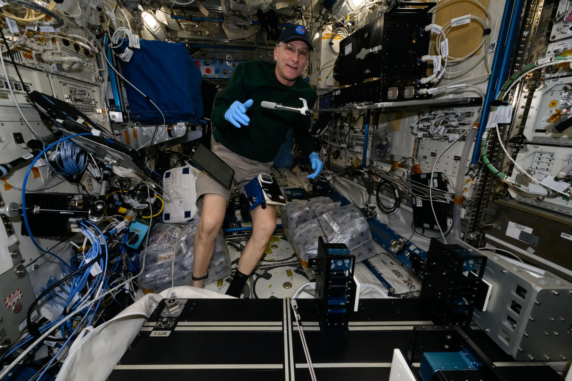 NASA astronaut and Expedition 72 Flight Engineer Don Pettit works on weekend housekeeping duties inside the International Space Station's Kibo laboratory module.