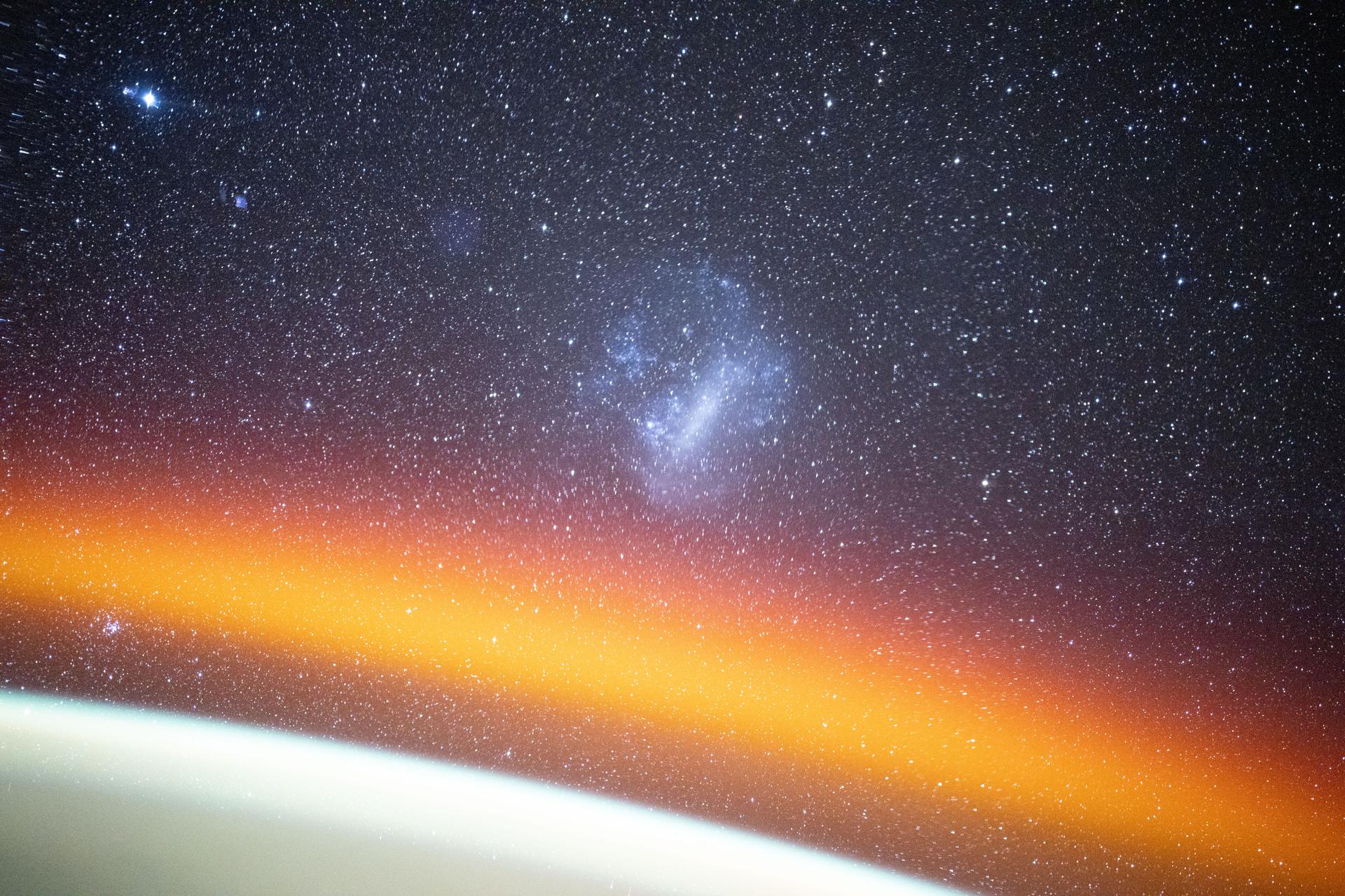 The Large Magellanic Cloud among a starry backdrop above Earth's atmospheric glow highlights this long duration photograph from the International Space Station as it orbited 260 miles above the Pacific Ocean off the coast of Mexico. Credit: NASA/Don Pettit