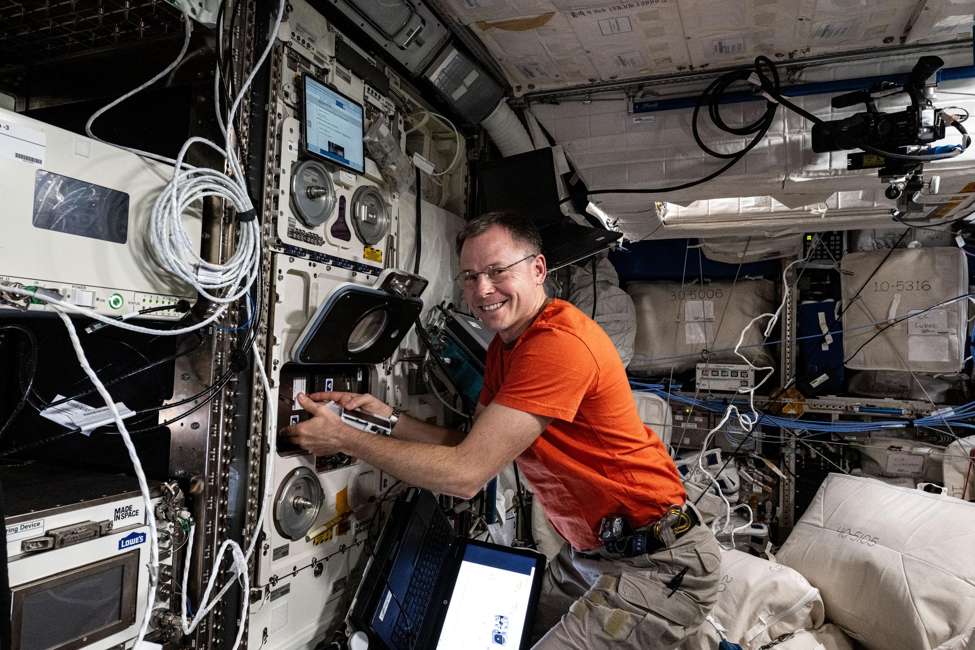 NASA astronaut and Expedition 72 Flight Engineer Nick Hague processes radiation-resistant samples of Arthrospira C micro-algae and stows them in an incubator for analysis inside the International Space Station's Columbus laboratory module. The samples will be exposed to different light intensities to observe how they affect the micro-algae’s cell growth and oxygen production. Results may advance the development of spacecraft life support systems and fresh food production in space.