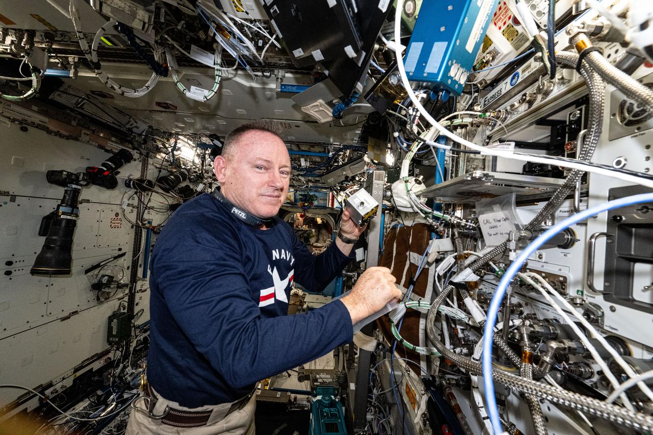 iss072e308299 (Dec. 2, 2024) --- NASA astronaut and Expedition 72 Flight Engineer Butch Wilmore shows off research hardware supporting a study that explores 3D printing on-demand medical devices on the International Space Station to treat Earthbound and space-caused health conditions.