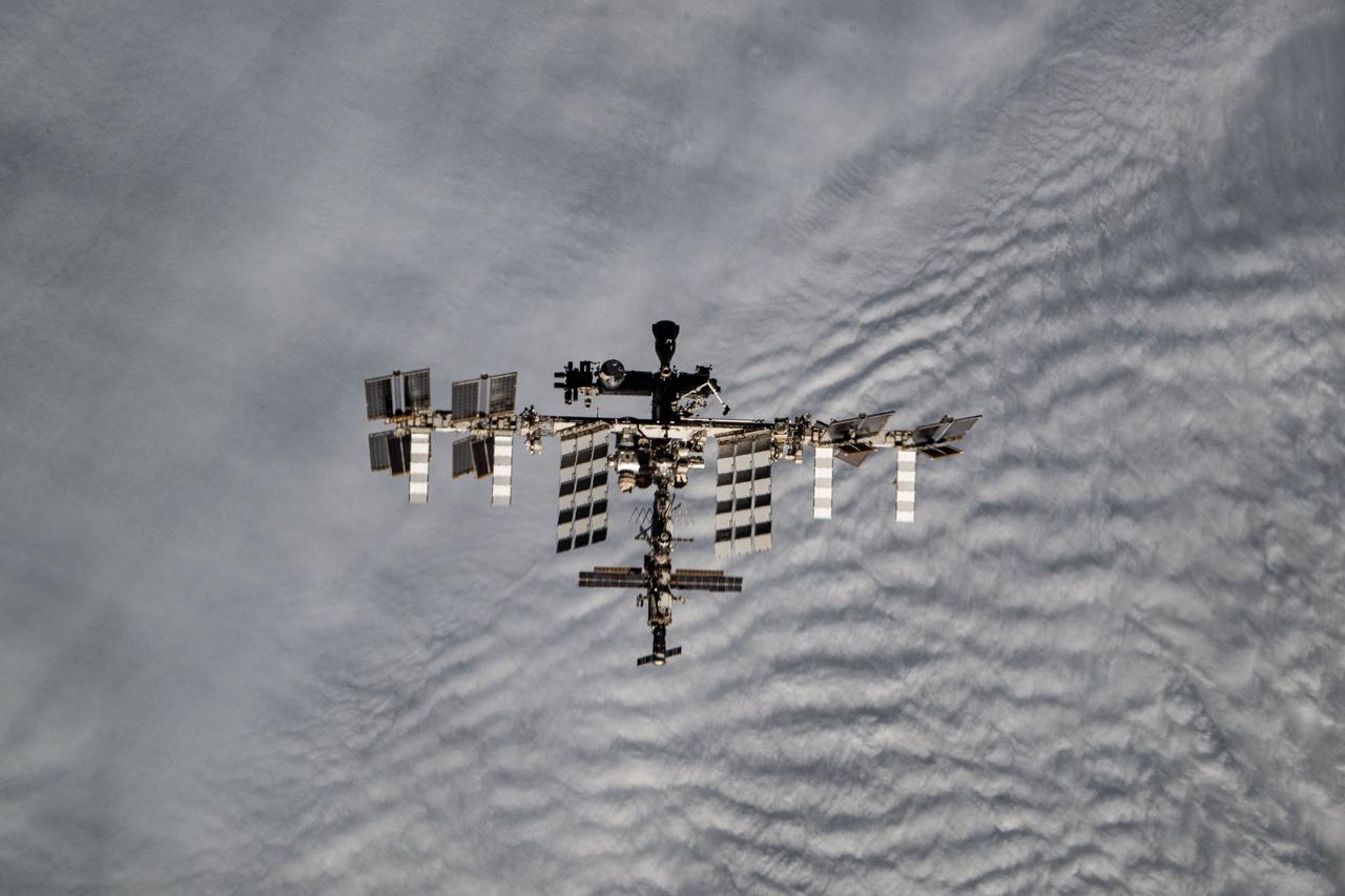 iss072e316172 (Oct. 23, 2024) --- The International Space Station is pictured from the SpaceX Dragon crew spacecraft by a SpaceX Crew-8 member shortly after undocking from the Harmony module's space-facing port. The orbital outpost was soaring 272 miles above the cloudy Patagonia region of South America at the time of this photograph.