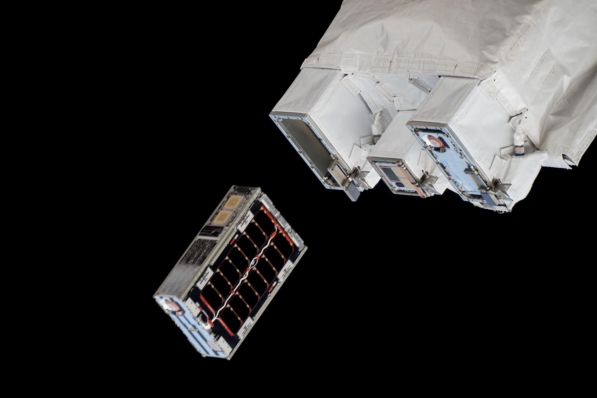 A CubeSat is ejected into Earth orbit from a small satellite orbital deployer attached to the International Space Station's Kibo laboratory module. A series of CubeSats were deployed into Earth orbit on Dec. 9, 2024, for educational research missions designed by Japanese high school and college students.