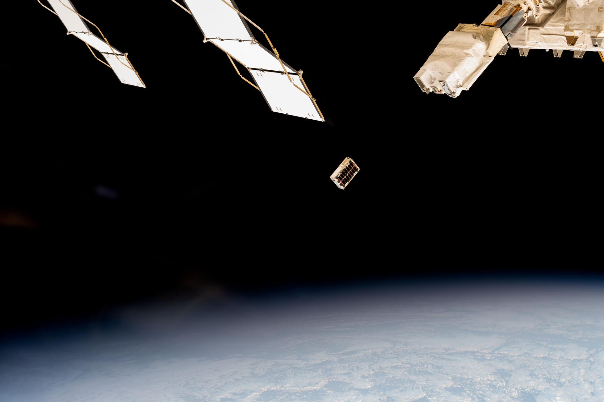 A CubeSat is ejected into Earth orbit from a small satellite orbital deployer attached to the International Space Station's Kibo laboratory module. A series of CubeSats were deployed into Earth orbit on Dec. 9, 2024, for educational research missions designed by Japanese high school and college students.